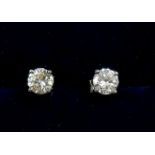 A pair of platinum set diamond stud earrings, just under 1ct in total