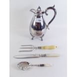 A silver plated water jug, silver plated cake fork, preserve spoon and cake knife