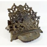 A brass correspondence rack with scroll decoration