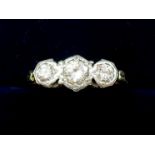 An 18 carat gold and platinum set three stone diamond ring