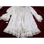 A Victorian muslin and net cape, a lace and net shawl and a silk and lace Edwardian blouse