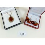 A silver and amber necklace and pair of silver and amber earrings