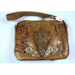 A crocodile skin handbag with head and feet