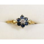 An 18 carat gold sapphire and diamond ring - size J