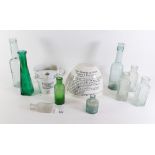 A group of glass bottles and a cornflour Blanc Mange mould and a measuring jug.