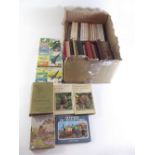 A box of small books including some Beatrix Potter