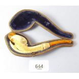 A 19th century carved ivory and amber mounted pipe in the form of a claw, cased