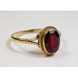 An 9 carat gold garnet ring - size O