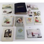 A small group of postcards and greeting cards and a momento album from 1914 onwards