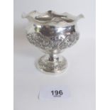 An Indian white metal small pedestal bowl with embossed floral decoration, 8.5cm tall, 69g