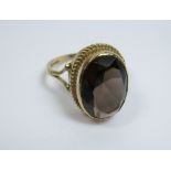 A 9ct gold smoky quartz ring - stone size 1.3cm tall - ring size M.