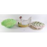 A bisque chicken in a basket egg holder (beak a/f), four Shorter & Sons fish plates and a green leaf