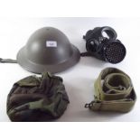 A WWII tin helmet, a gas mask 1942 and a belt
