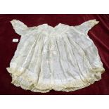 An Edwardian silk and embroidered baby dress with lace trim