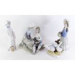 A Nao group romantic couple with grapes and two other Lladro style figures