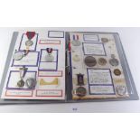 A folder of Royal Family commemorative medals and medallions - all mounted and taped on card.