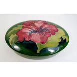 A Moorcroft small lidded oval box in the Hibiscus pattern. A/F.