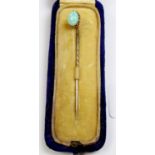 A gold and opal set stick pin, cased, unmarked but tested gold