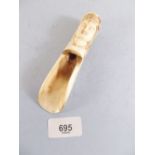 A small carved bone shoe horn in form of an Indian princes head - 13.5cm