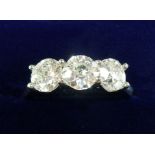 A platinum set three stone diamond ring - size M 1/2 - 1.5 carats total