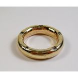 A 9 carat gold ring inset four diamonds to sides - one stone deficient - 11.7g