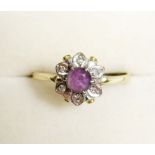 An 18 carat gold diamond and amethyst cluster ring, size S