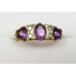 A 9ct gold ring set with 3 amethysts and 4 small diamonds - size O.