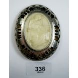 A large silver framed oval ivory brooch carved seated artist, 7.5 x 6cm overall size, Sheffield