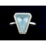 An 18 carat white gold ring set trapeze cut aquamarine - 2.23 carats - within diamond surround -