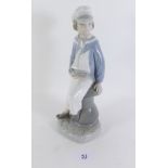 A Lladro figure boy with yacht