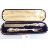 A Victorian silver knife and fork with embossed scrollwork decoration, by Aaron Hadfield,