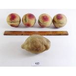 Four Victorian carved and painted marble peaches and a lemon