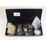 A small box of wristwatch spares including dials, movements and hands etc