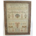 An 18th century sampler with text 'The Loss of Gold....' and motifs such as flowers and trees, by