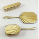 A silver and enamel three piece brush and mirror set Birmingham 1935