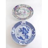 A Chinese Canton plate painted figures and a Chinese blue and white plate painted hunting scene