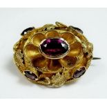 A Victorian 15ct gold (tested) and amethyst brooch - 2.5 grams, 2cm wide