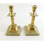 A pair of brass candlesticks in 17th century style