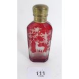 A 19th century Bohemian ruby cased glass scent bottle with gilt metal top - the glass engraved