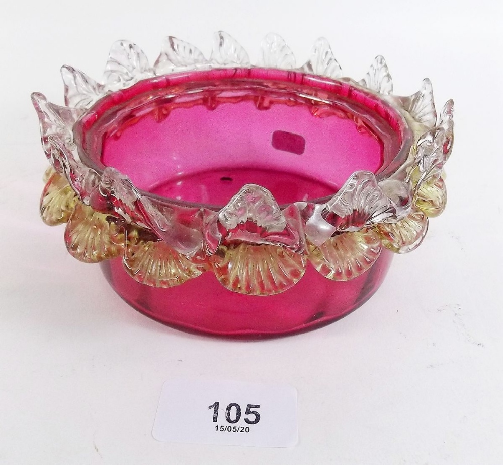 A 19th century cranberry glass bowl with frilled edge