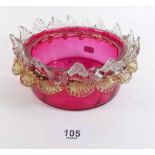 A 19th century cranberry glass bowl with frilled edge