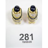 A pair of 18 carat gold earrings set cabochon cut sapphires and brilliant cut diamonds