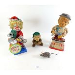 A clockwork vintage monkey with cymbals, a clockwork mouse and two vintage battery clown toys