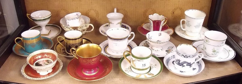 A collection of thirteen decorative continental cups and saucers including Limoges, Hollohazen etc