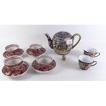 Five Chinese tea bowls and saucers decorated in iron red, and a Chinese Satsuma teapot and two