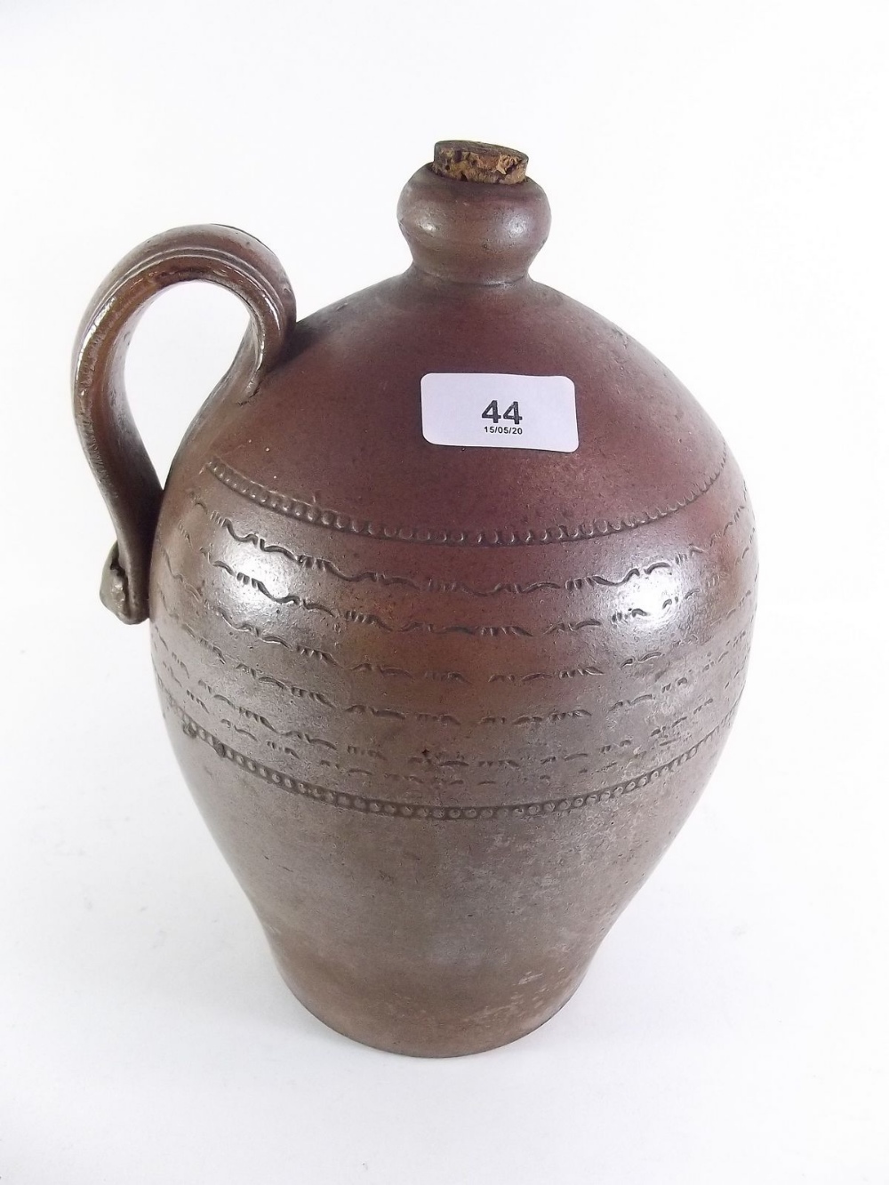 An antique stoneware flagon - 30cm