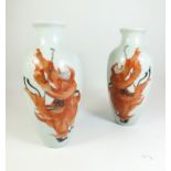A pair of Chinese Republic period porcelain 'rouge de fer' vases decorated with a scholar and boy