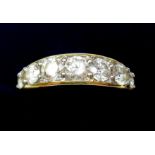 An 18 carat gold ring set seven graduated diamonds - size M - 1.5 carats in total