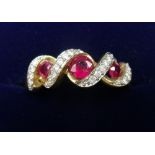A gold ring set three rubies with interlaced diamond setting - size M