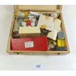 A box of spare wheels and balances/springs for early wristwatches
